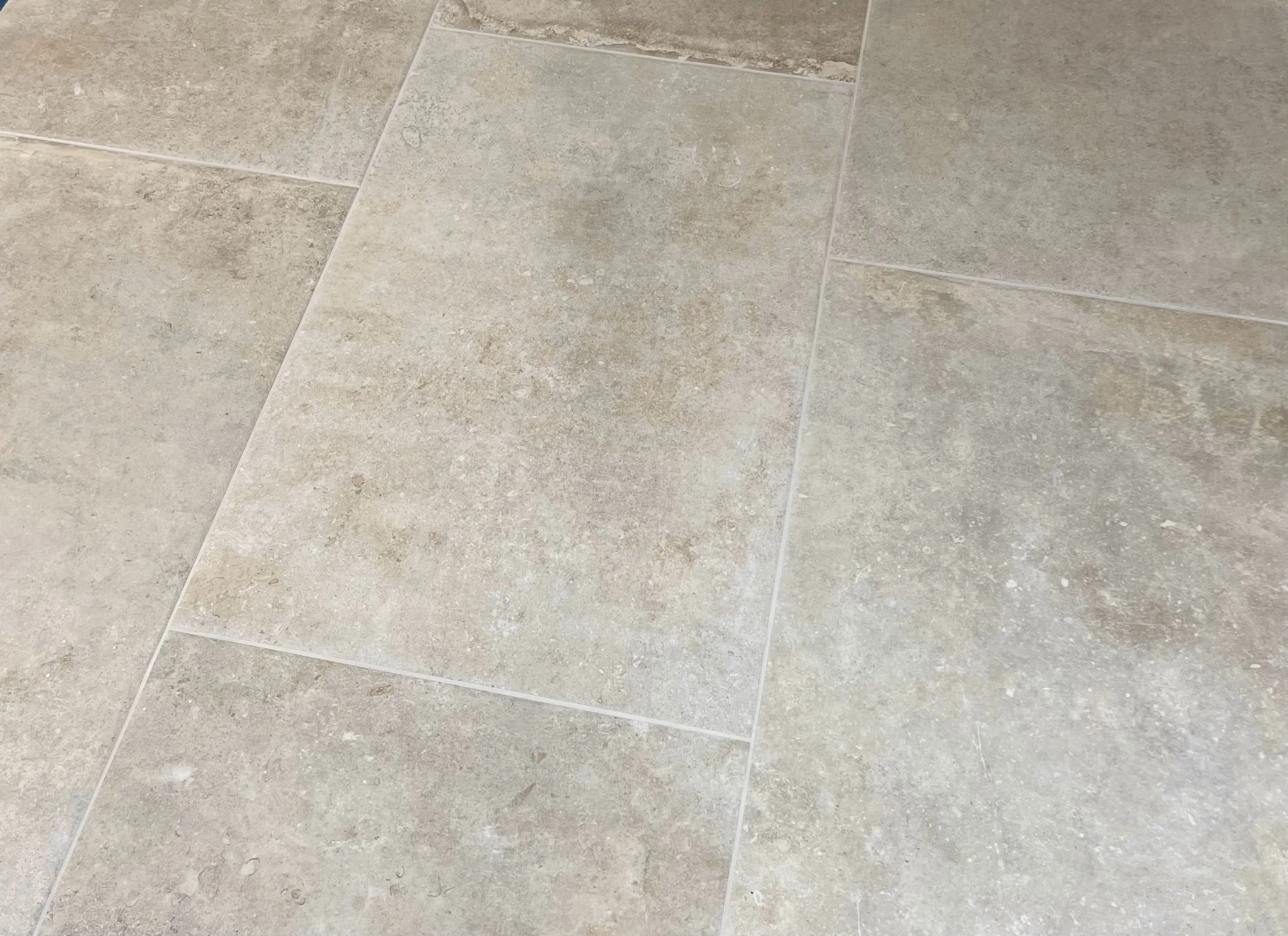 Parade Sand porcelain tile in a kitchen floor setting with warm sandy limestone tones and natural stone variation