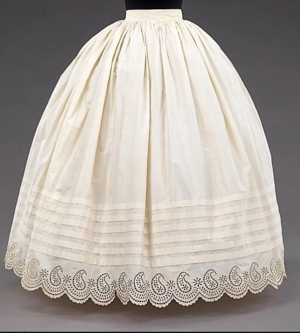 This wonderful array of cotton petticoats, dating from the 1850s to the 1860s, are from the Metropolitan Museum of Art. The waists are gathered with cartridge pleats, a clever way of controlling the vast swathes of fabric required for the full skirts