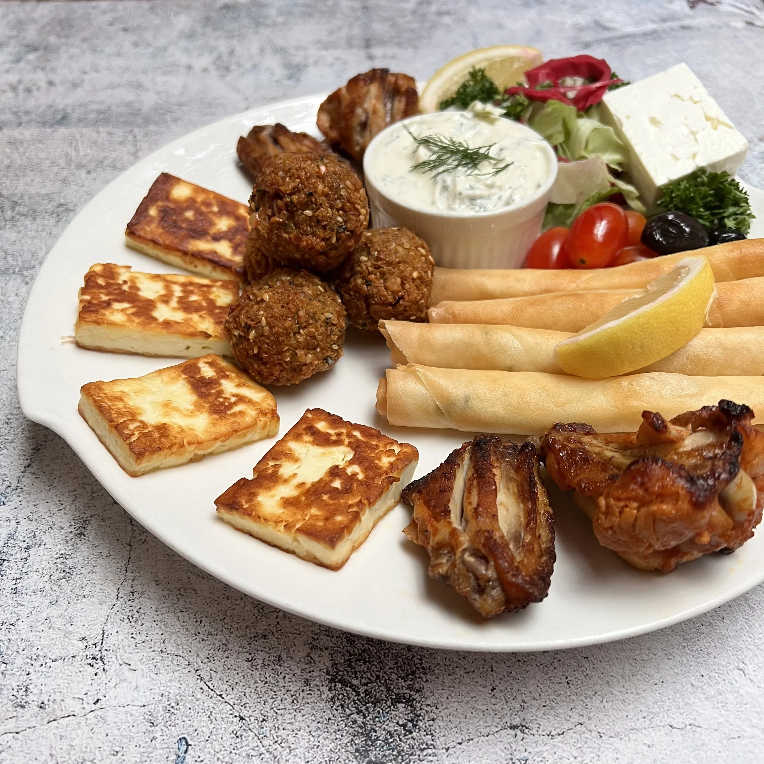 Turkish restaurant serving Mediterranean platter with appetizers.