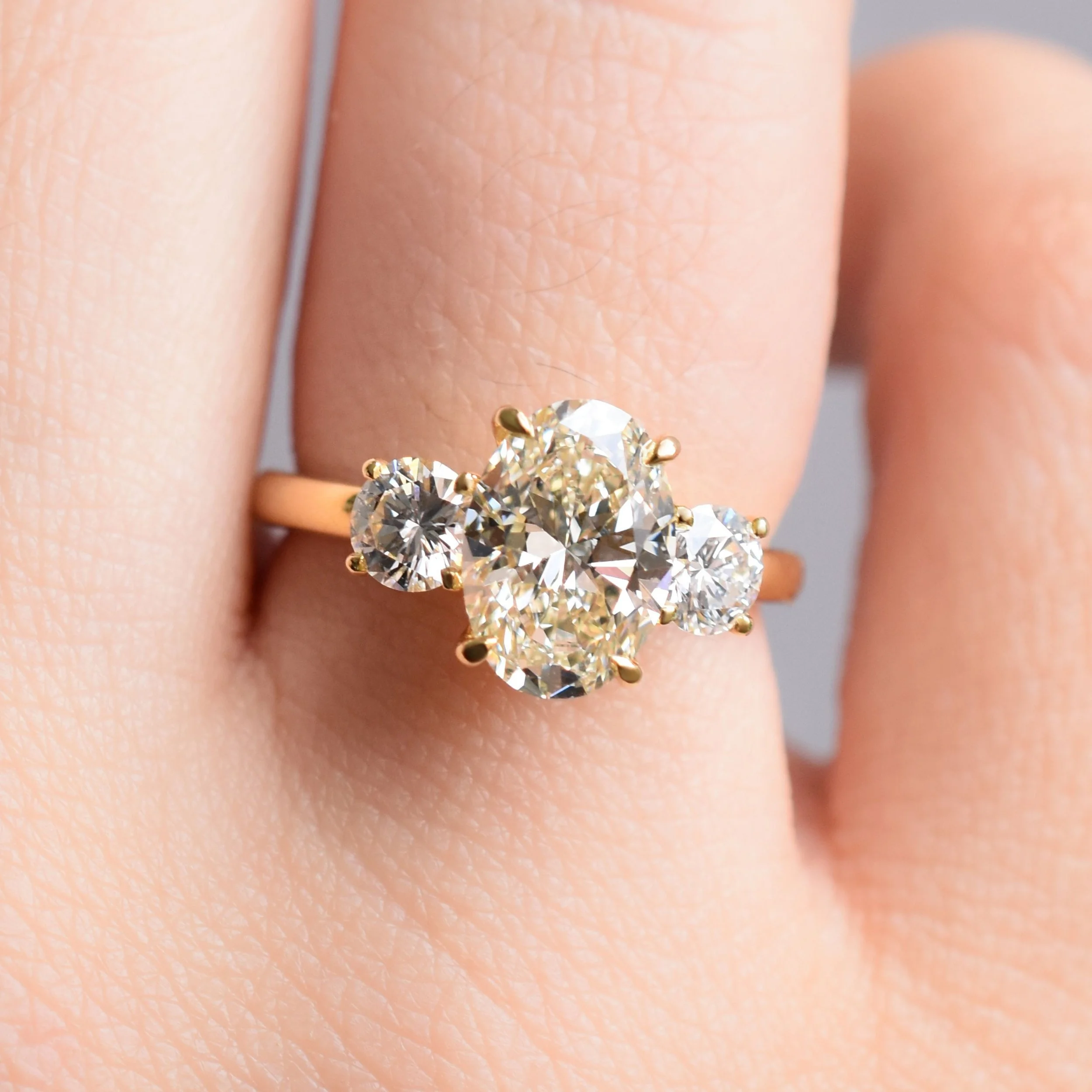 Christie Oval champagne diamond three-stone ring in champagne gold2.jpg
