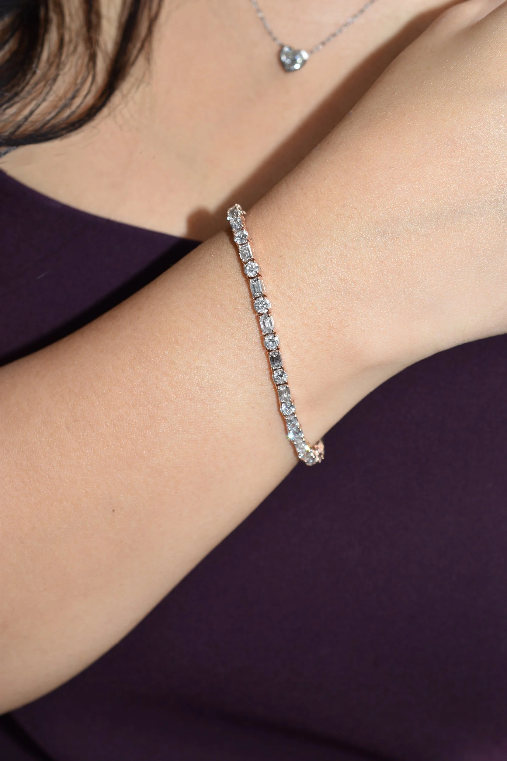 Verona diamond tennis bracelet in rose gold with round and emerald-cut diamonds, worn on the wrist, by August Bespoke Singapore