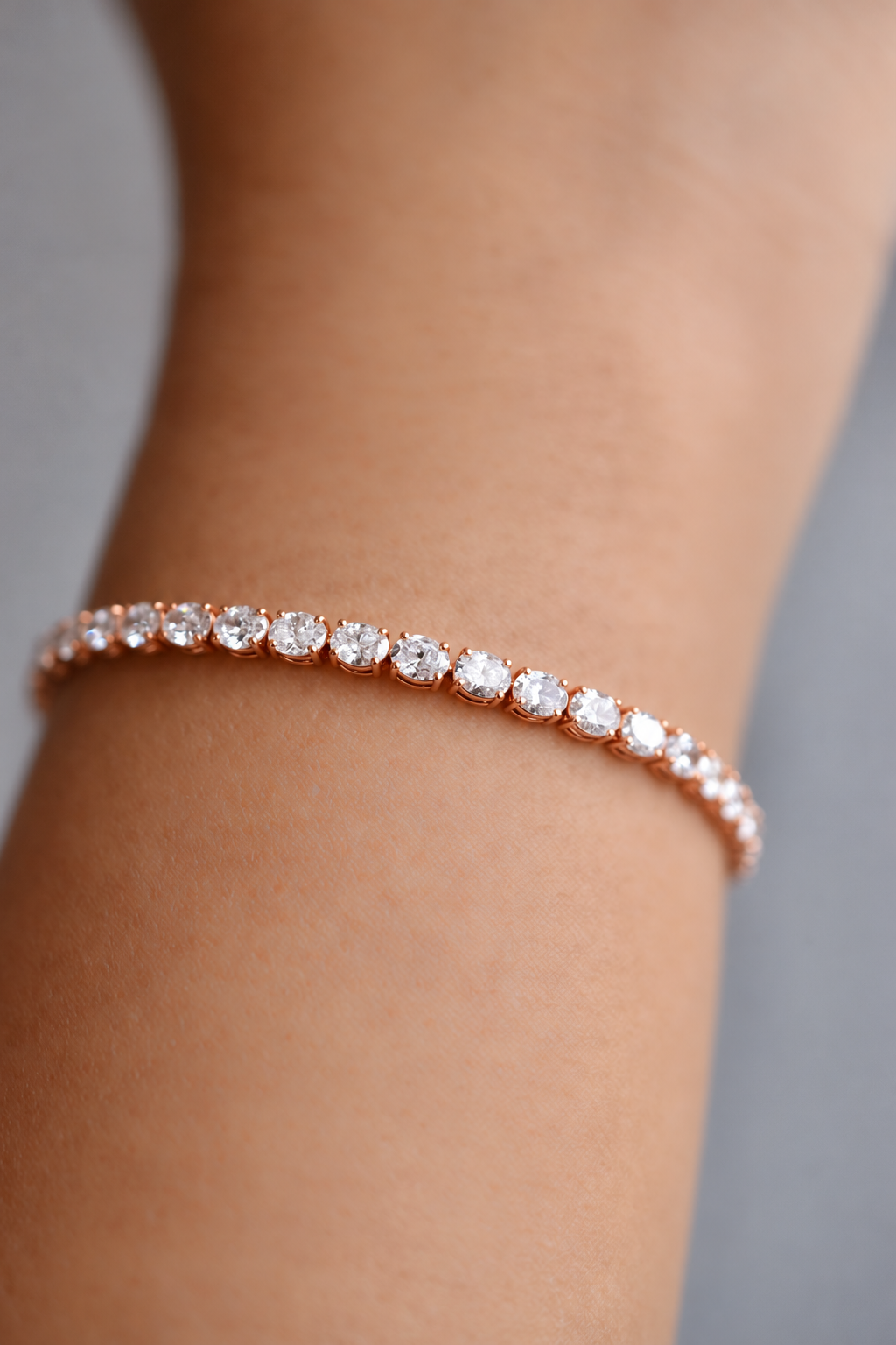 Colette east-west oval diamond tennis bracelet in rose gold, worn on the wrist, by August Bespoke Singapore