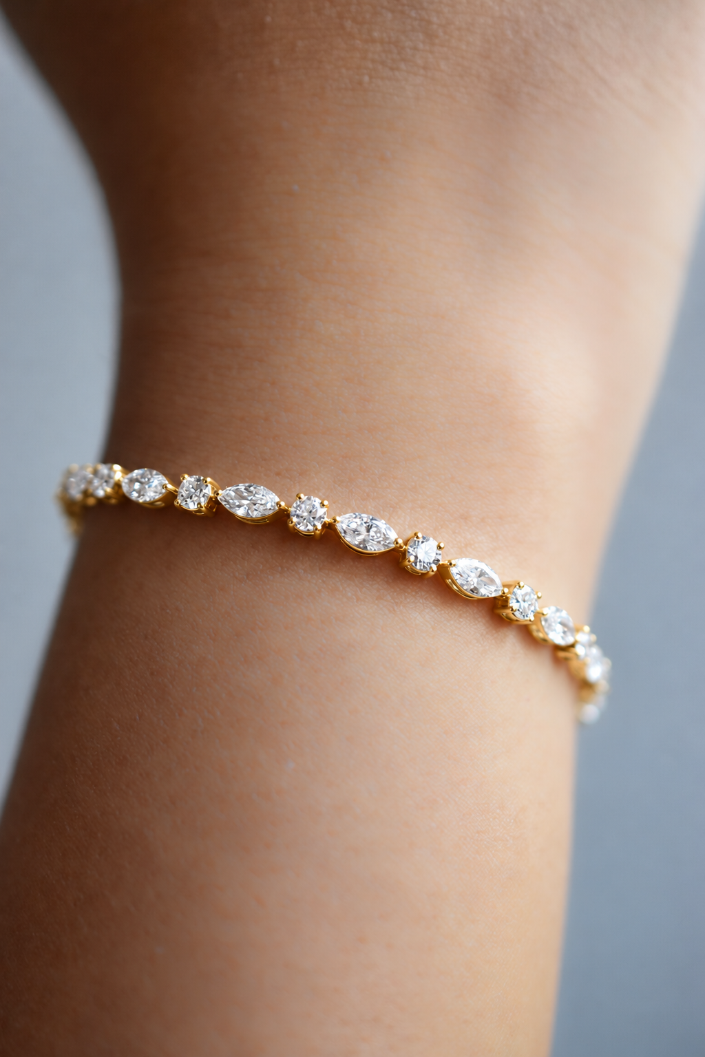 Élodie diamond bracelet in yellow gold with round and marquise diamonds, worn on the wrist, by August Bespoke Singapore