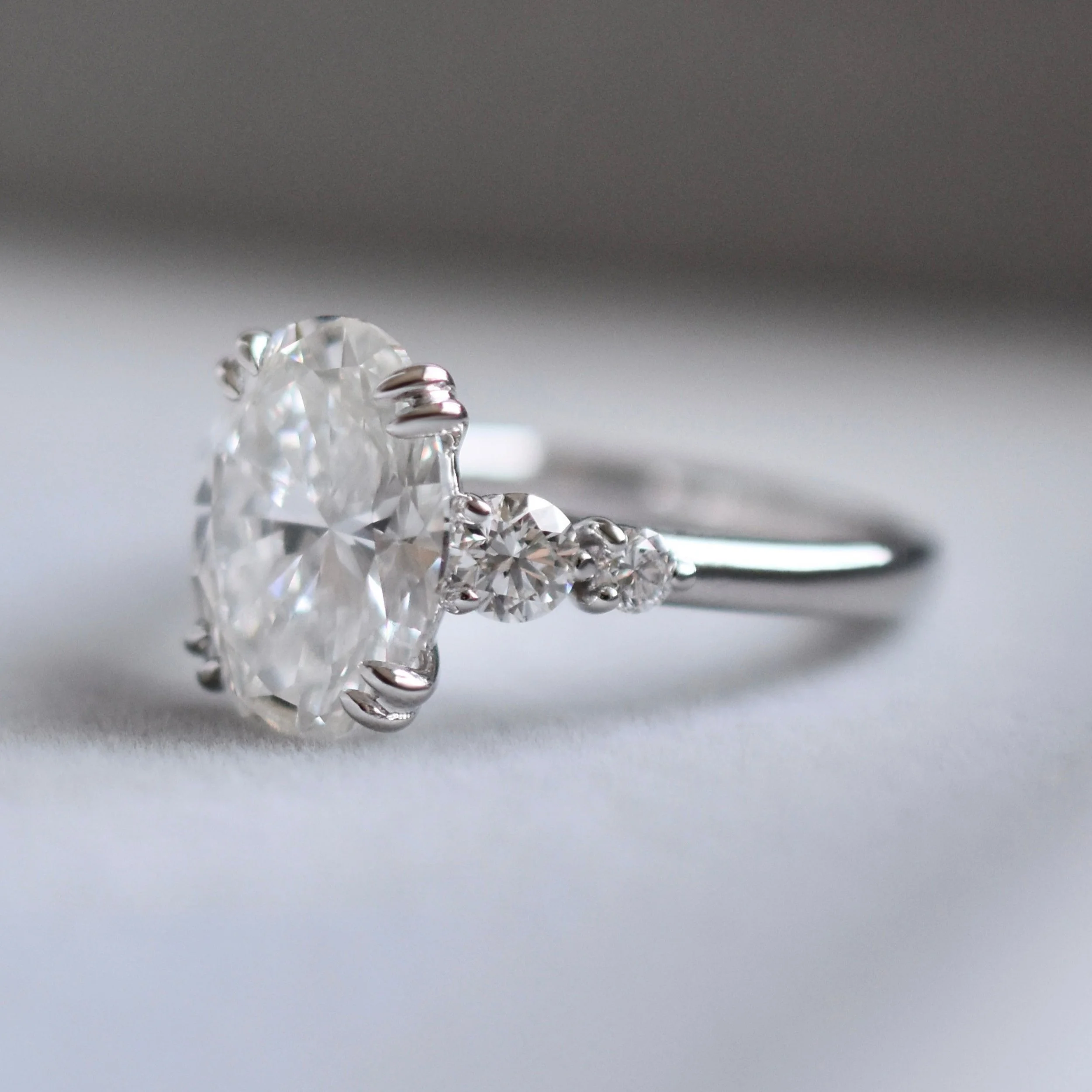 Valora Oval Diamond Ring with Graduated Round Side Diamonds in White Gold3.jpg
