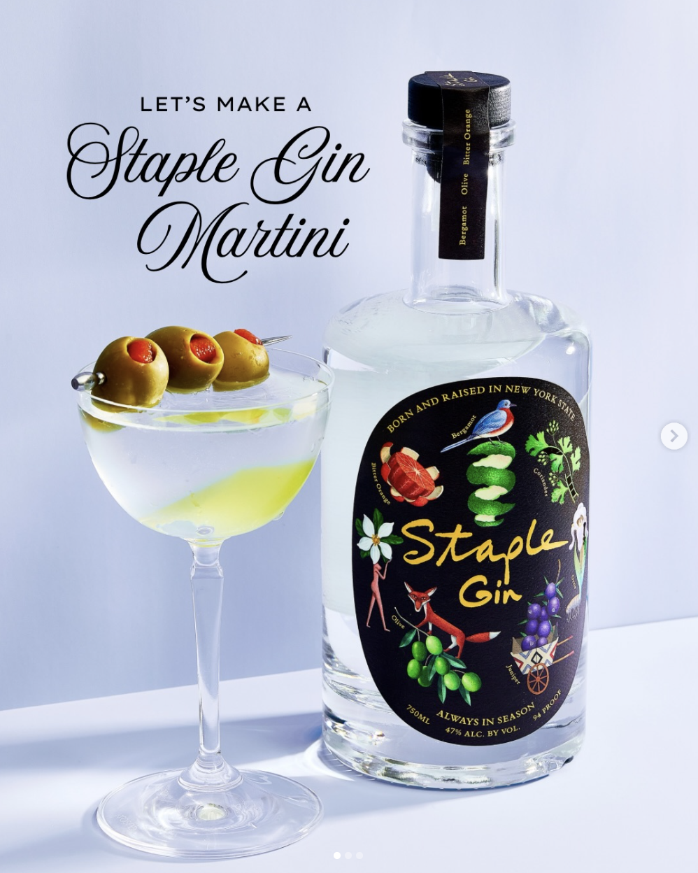 A bottle of Staples Gin and a cocktail glass with green olives and cherry tomatoes, set against a light background, with text promoting a staple gin martini.