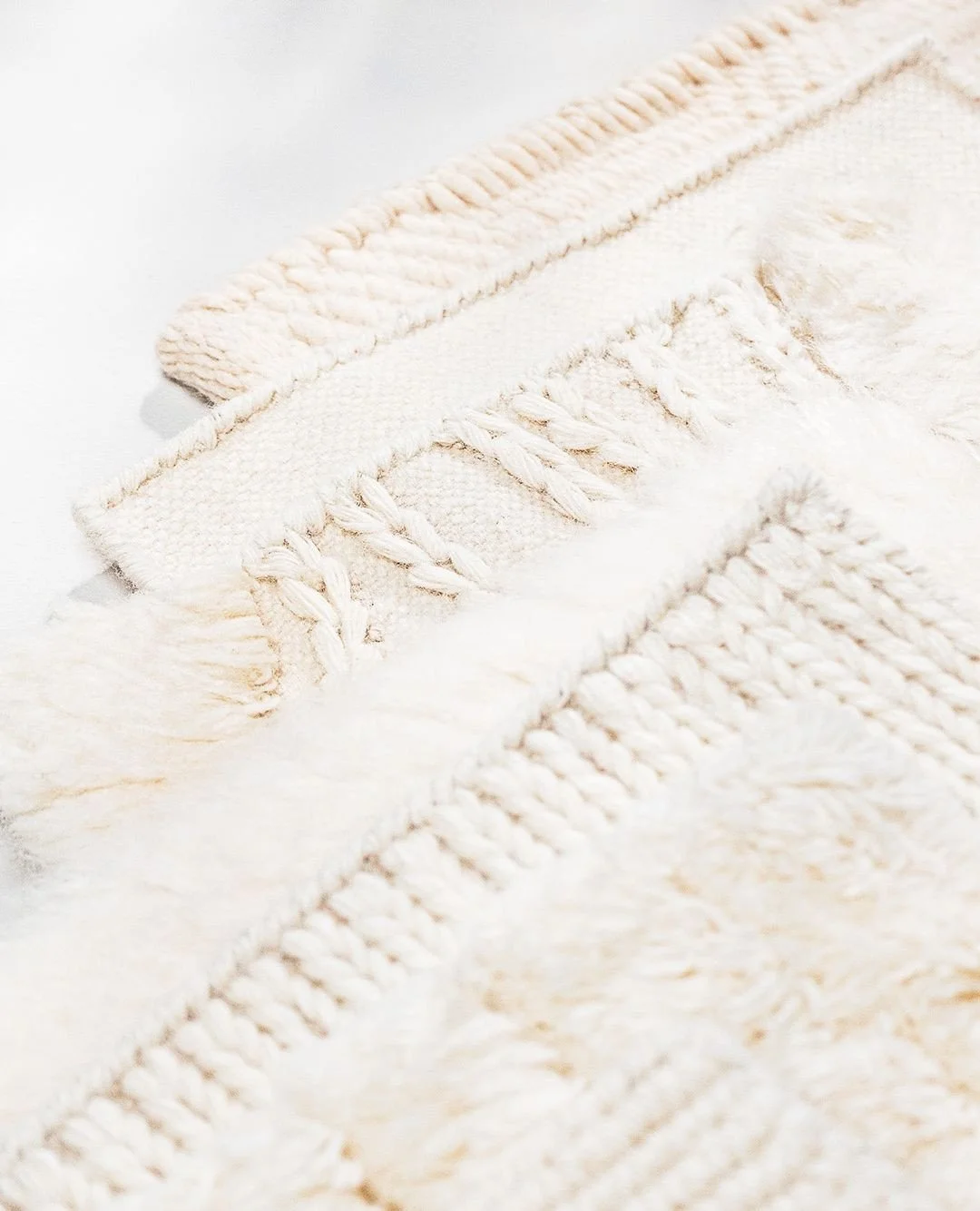 Each thread carries the quiet rhythm of the loom, handwoven in wool with a depth you can feel as much as you see. These close-up studies capture the subtle shifts of texture that emerge in the mill, where craft and patience shape every surface into s