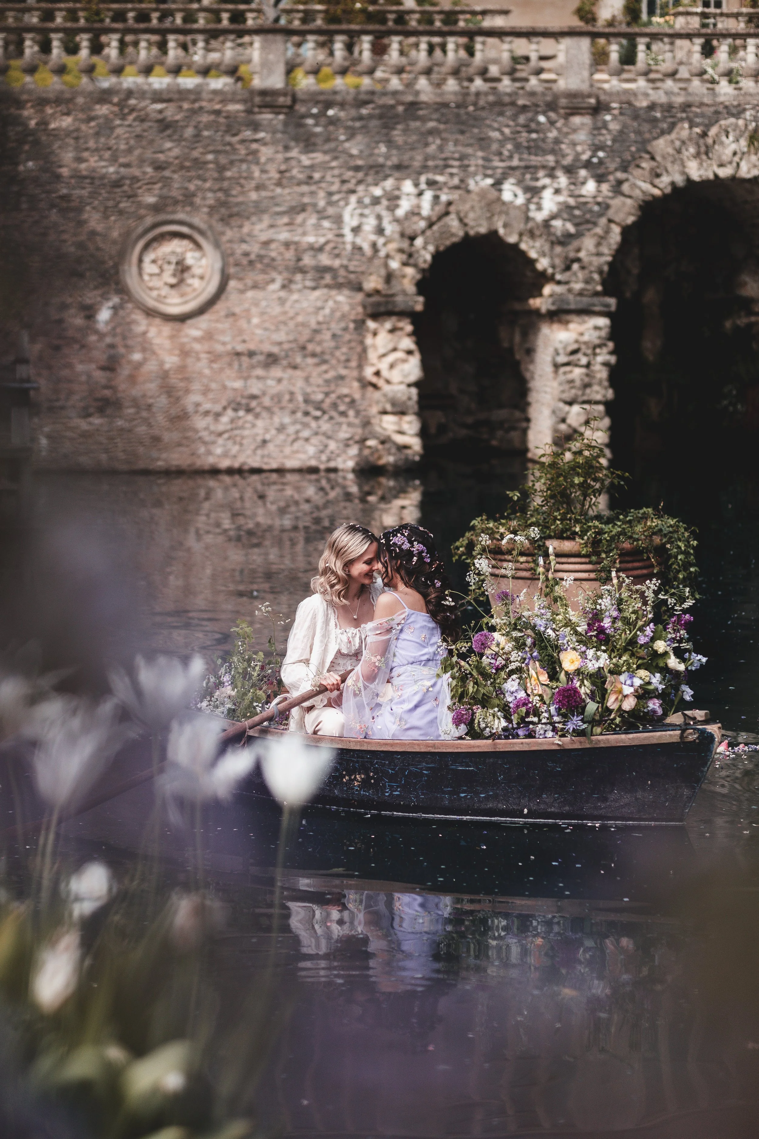 Whimsical couple portraits on the boat on the lake at Euridge Manor in The Cotswolds, U.K.