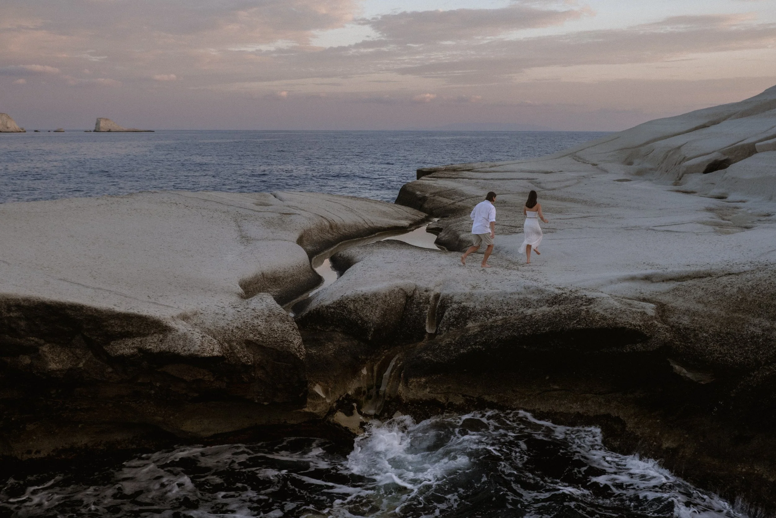 Elopement photos at Sarakiniko beach at sunrise. Milos elopement photographer