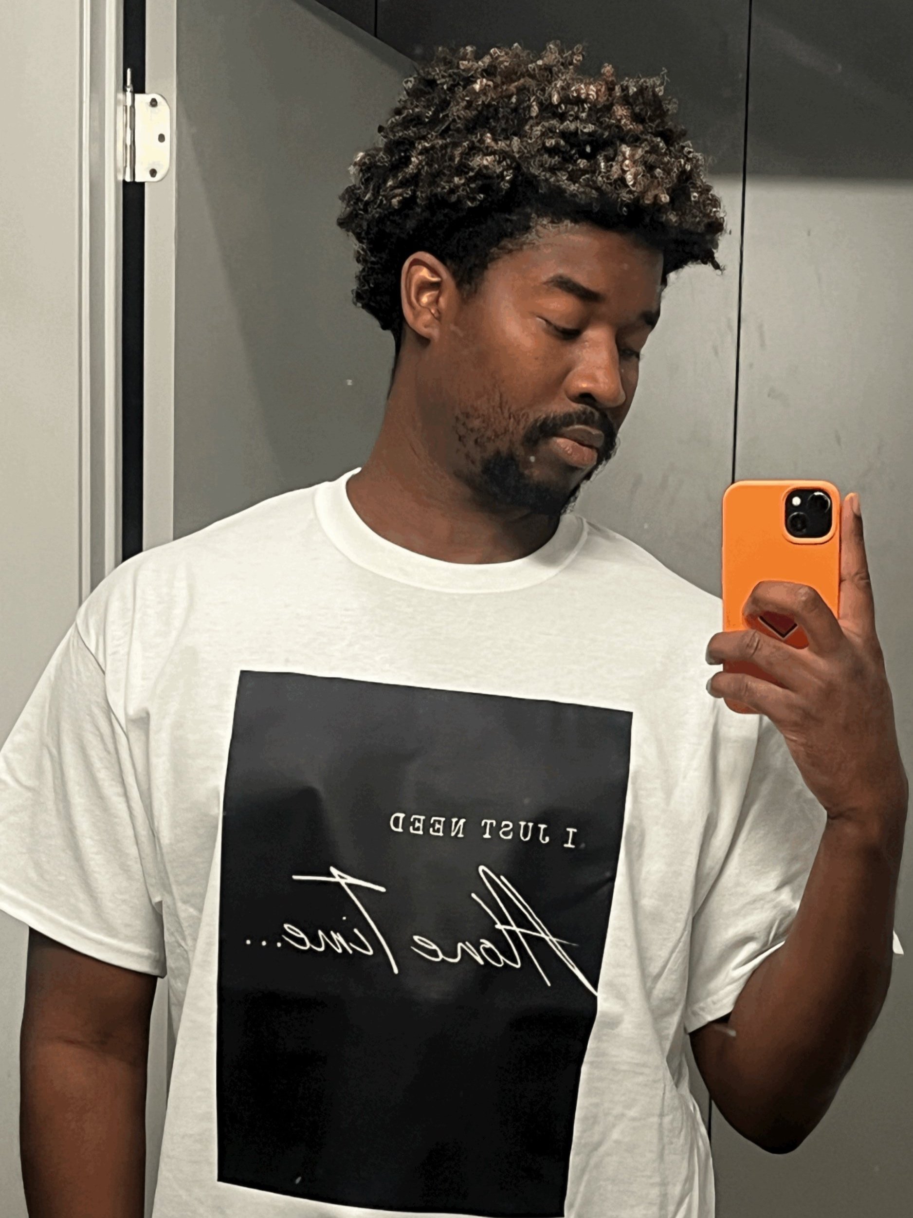 Joseph Valenté bathroom selfie in the black and white Alone Time T shirt with a graphic that says I Just Need Alone Time
