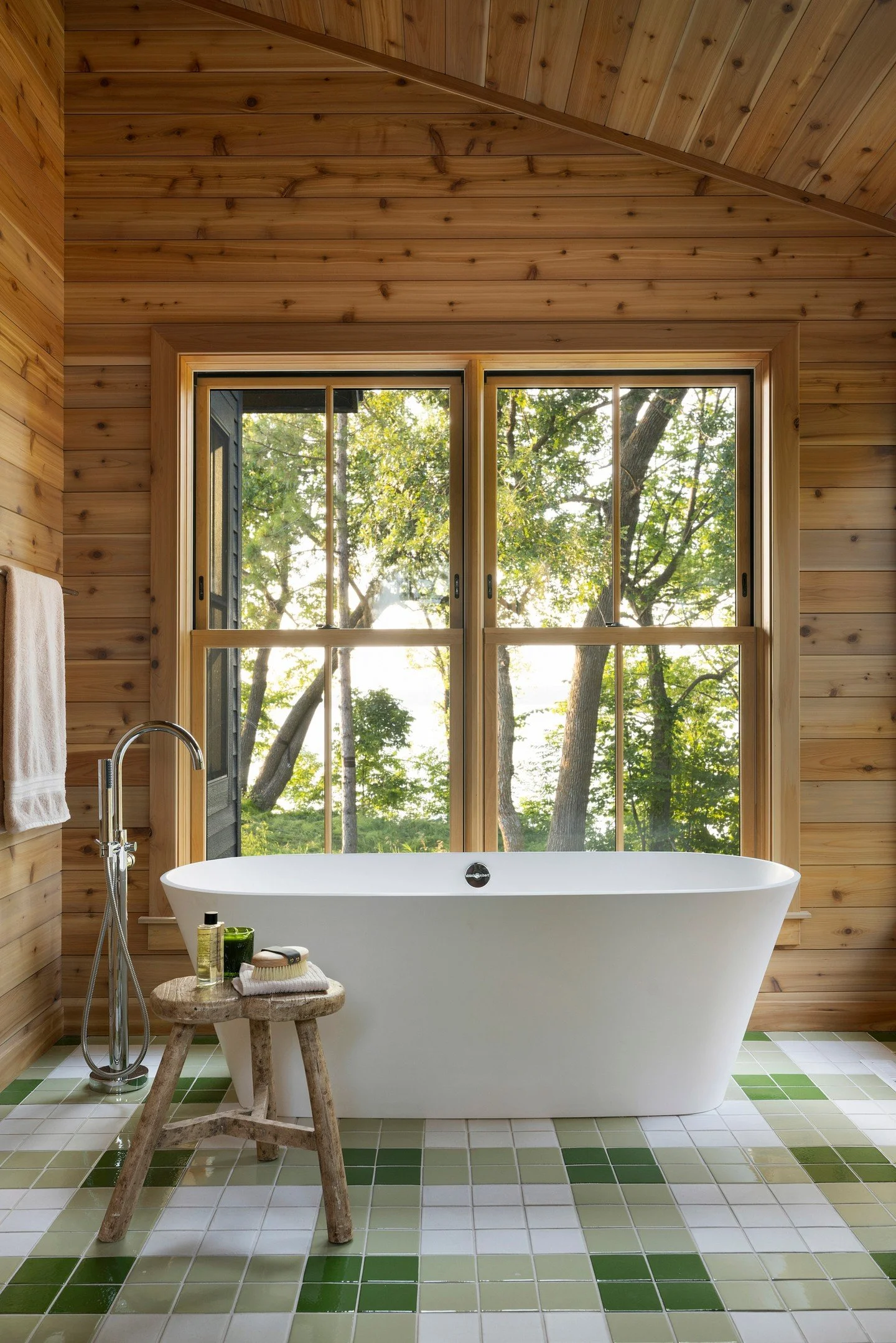 💚 Vacation Vibes, Everyday 💚⁣
⁣
The tranquil Whitefish Point Primary Bath feels like a serene retreat &mdash; a place where time slows down and the world melts away. The custom tile pattern adds artistry and individuality. And how about the view?! 