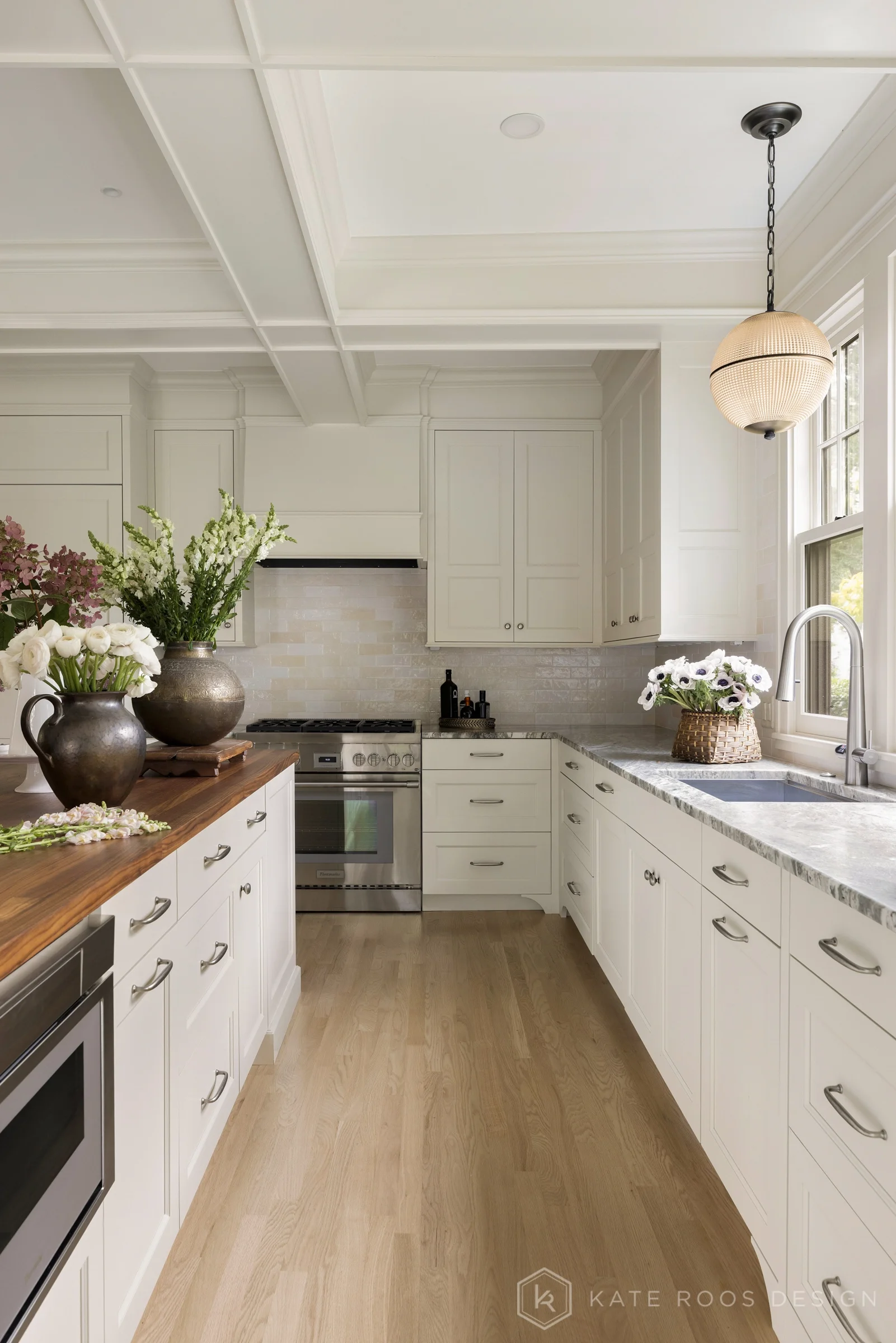 A beautiful balance of traditional architecture and modern functionality, the Christie Kitchen is a study in thoughtful details, refined materials, and timeless design.

Warm white custom cabinetry, an architectural coffered ceiling, and delicate pat