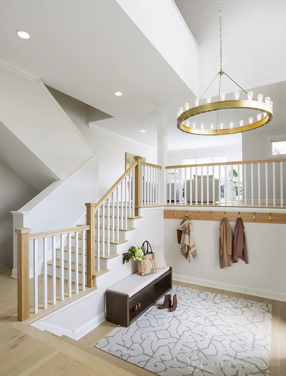 This airy and inviting living room by Kate Roos Design, an esteemed interior designer in Minneapolis, balances modern sophistication with everyday comfort. A soft neutral palette, layered with rich leathers, textured upholstery, and organic forms, cr