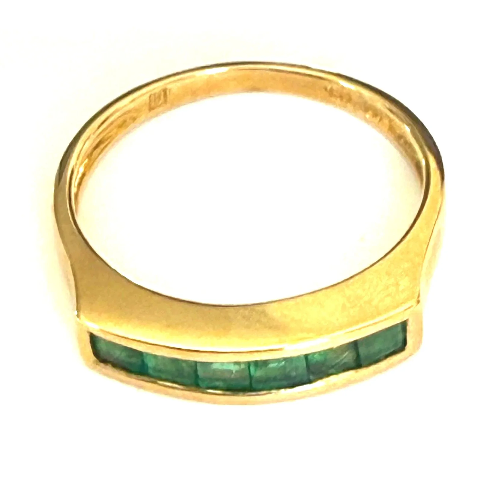 246.  Lady's 14K yellow gold, emerald band, 2.61 grams, size 6.5, stamped 14K and 585, in very good condition. Appraisal Certificate included Value $1500.