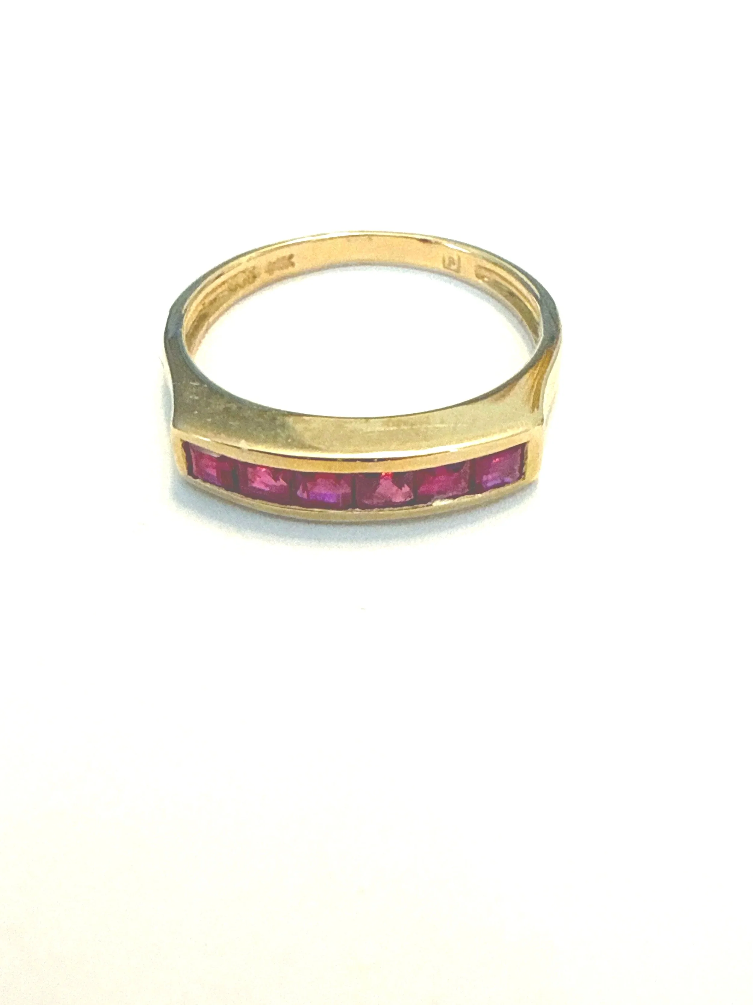253.  Lady's polished 14K yellow gold, ruby band, size 5.5, 2.63 grams, stamped 14K & 585, in very good condition.  Appraisal Certificate included Value $1750.