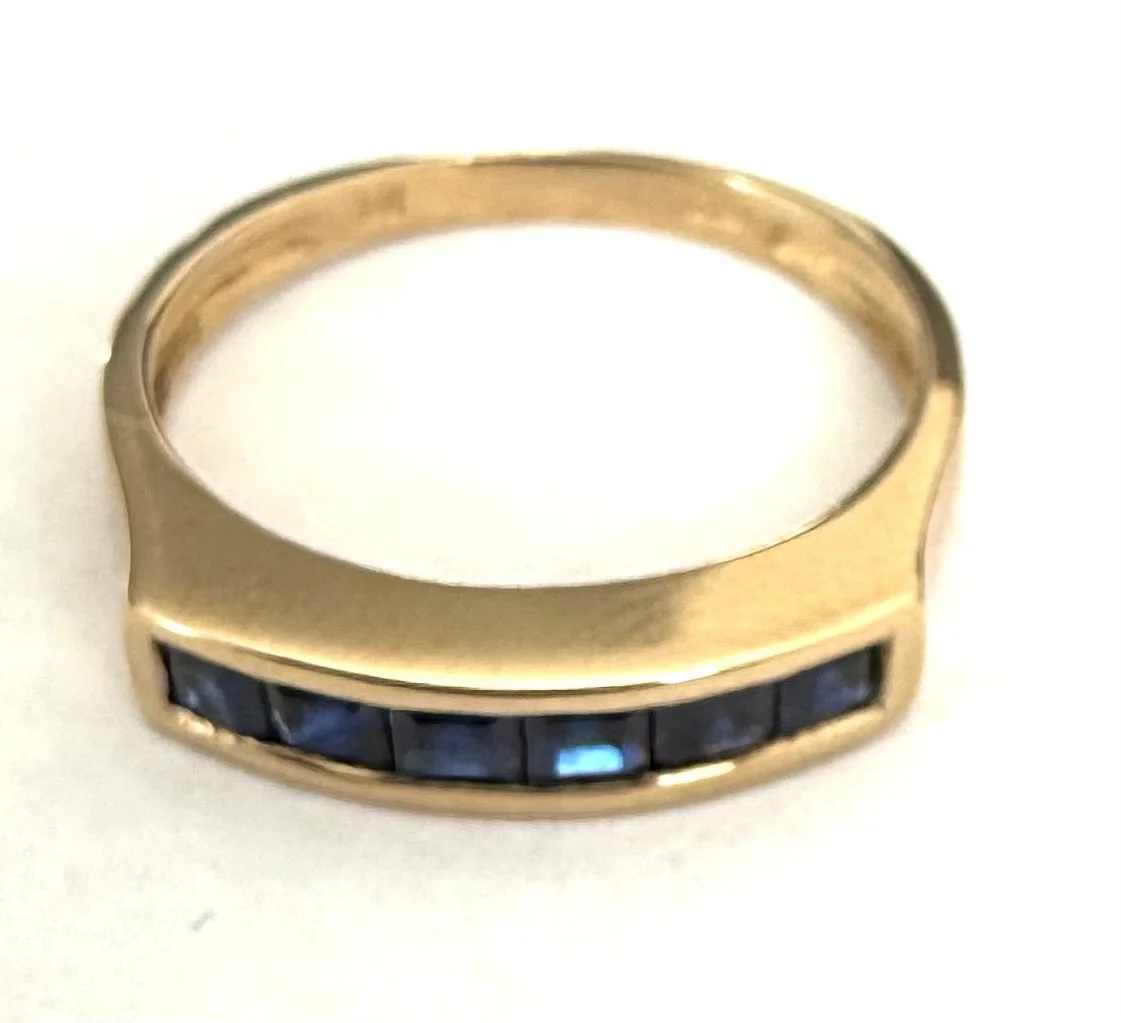 247.  Lady's 14K yellow gold, sapphire band, 2.68 grams, size 6.5, stamped 14K and 585, in very good condition.  Appraisal Certificate included Value $1700.