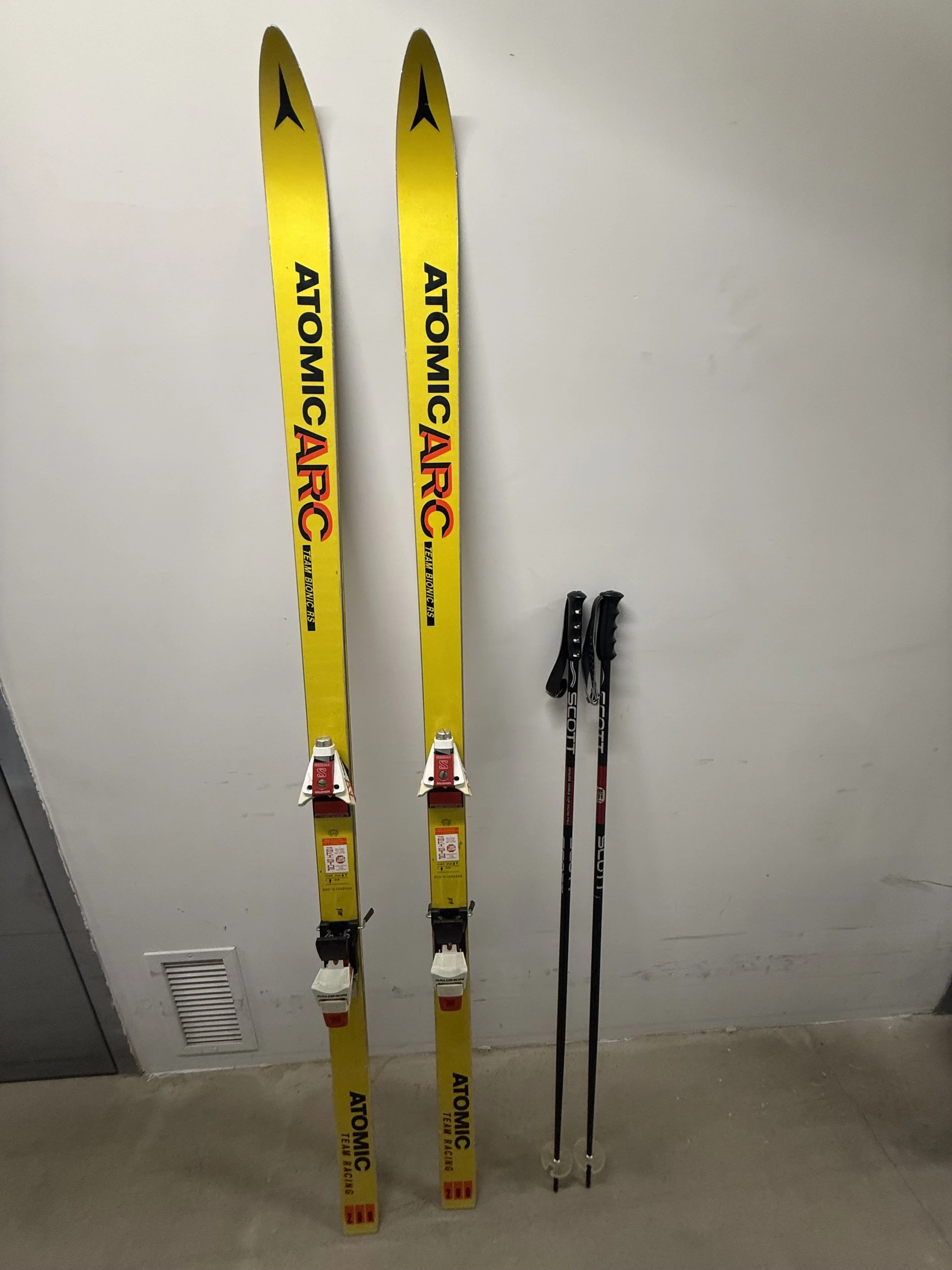 134.  Atomic Arc Team Racing RS skis (79"), Salomon bindings and Scott poles