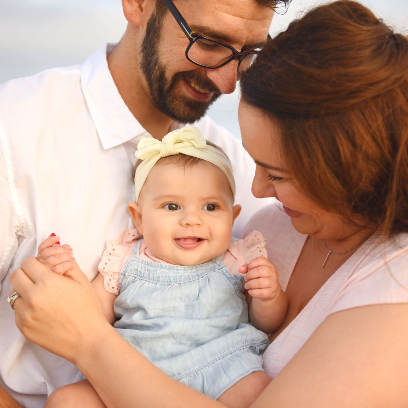 Parents Holding Baby Daughter at Photoshoot in Newport Beach