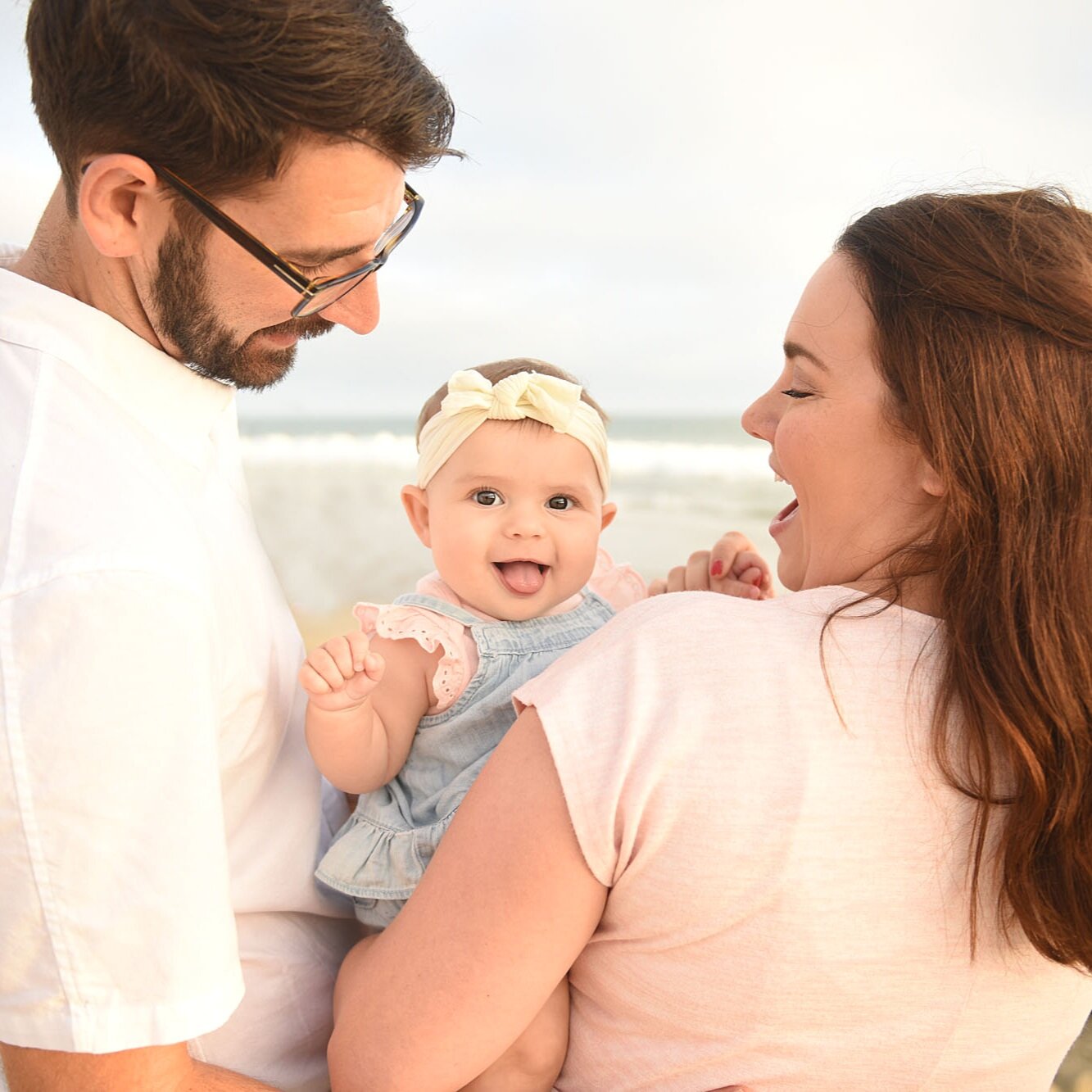 Happy newborn with parents in Huntington Beach CA