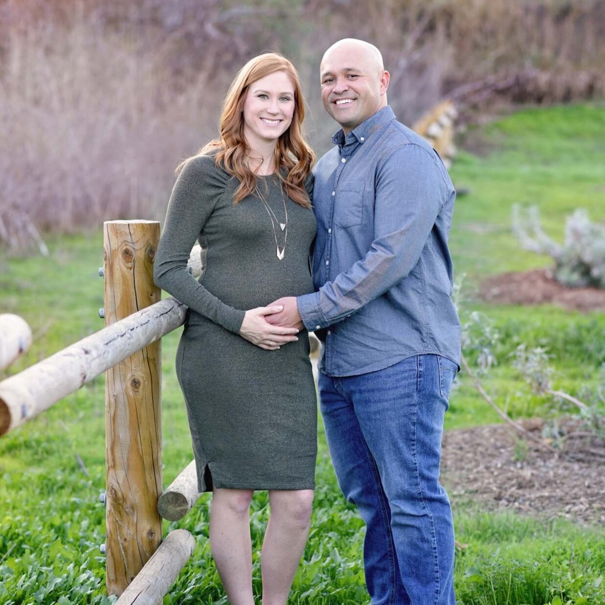 Couple smiling for maternity photos in Orange County CA