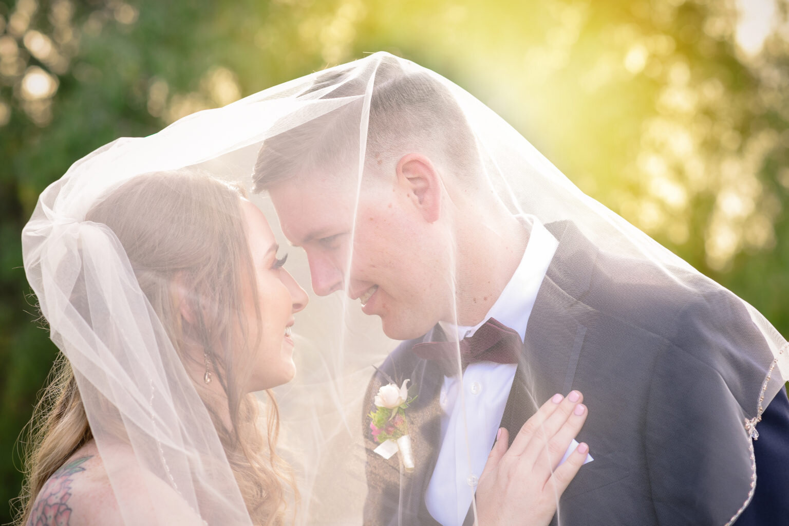 Bride and groom under bridal veil in Fullerton CA