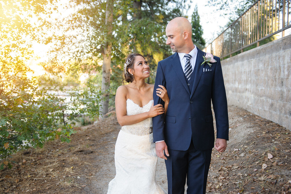 Bride holding arm of groom at wedding in Orange County CA