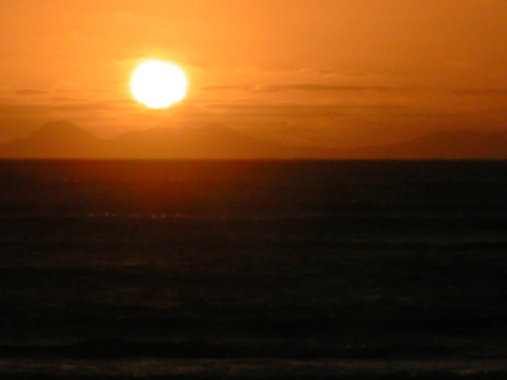 Sunset over ocean and mountains