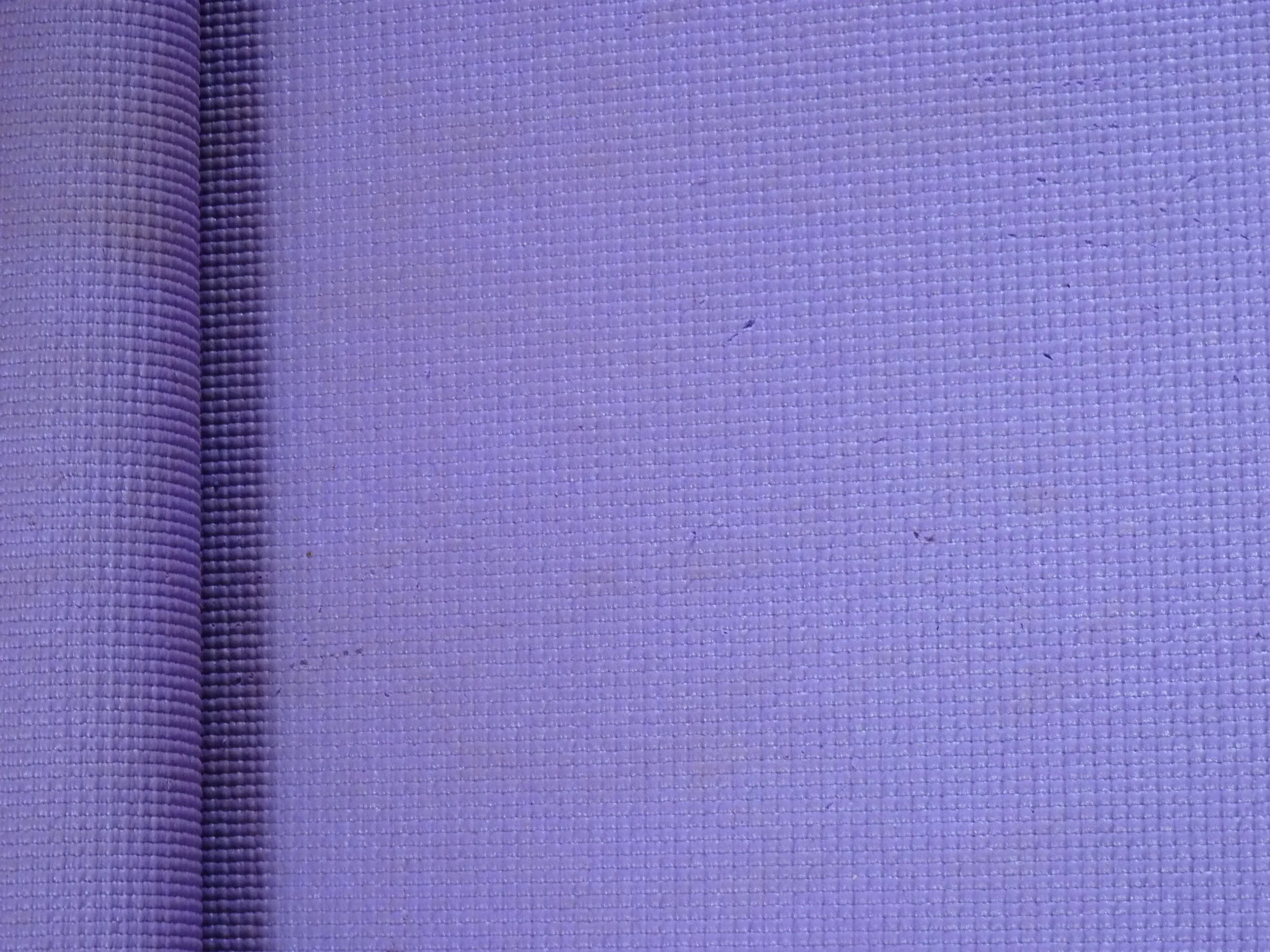 Close-up of a purple yoga mat with textured surface