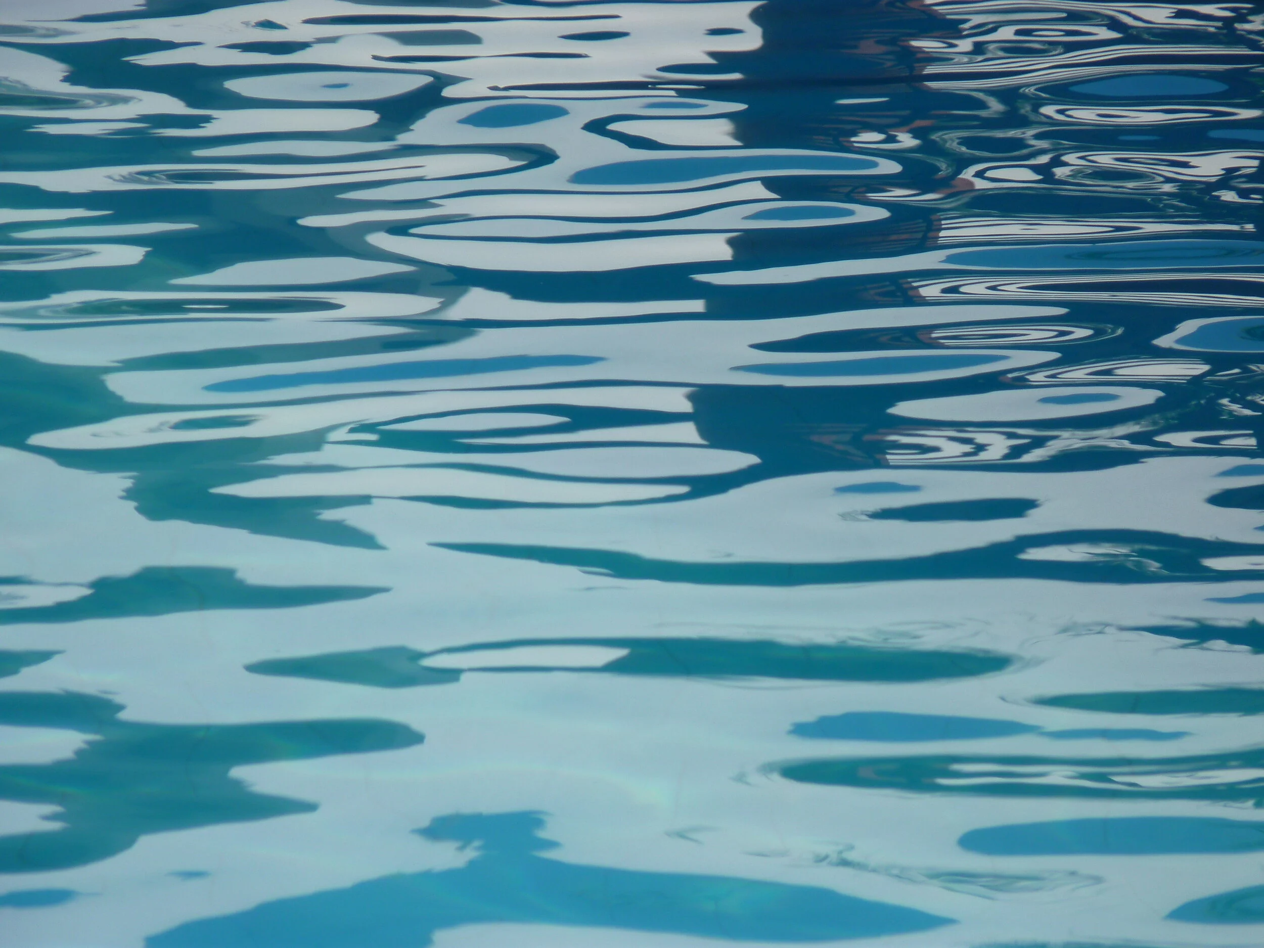 Ripples in a pool of water with reflections.