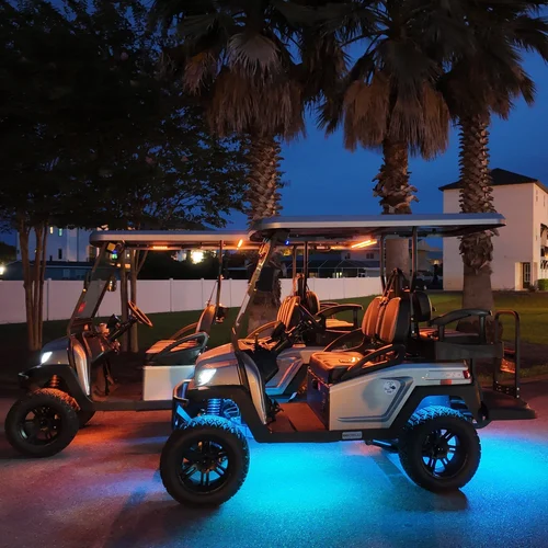 Beach Better golf carts with party-light glow at night on the Emerald Coast