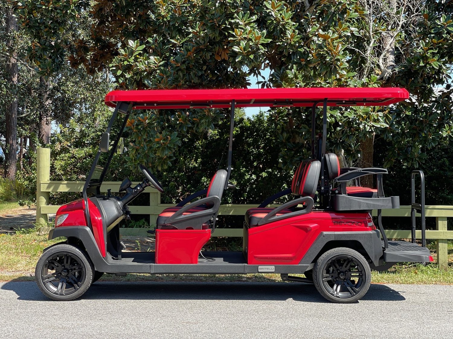 RB78L red 6 seat electric street legal golf cart LSV parked on the Emerald Coast