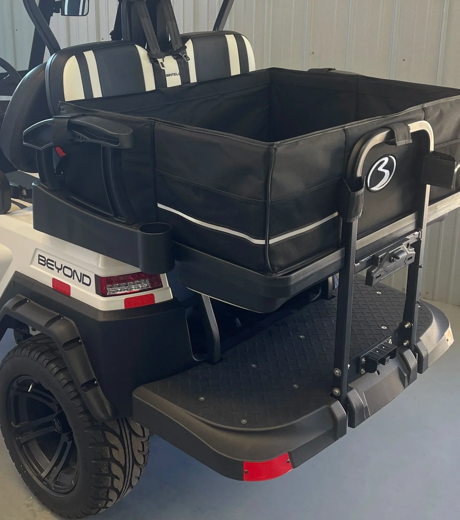 Detail view of the empty Beach Better removable storage box installed on the rear-facing row of a Bintelli Beyond rental cart