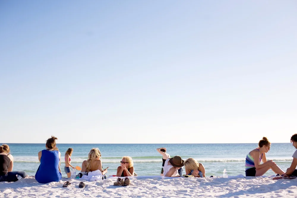 Families enjoying the white-sand beach on Florida's Emerald Coast