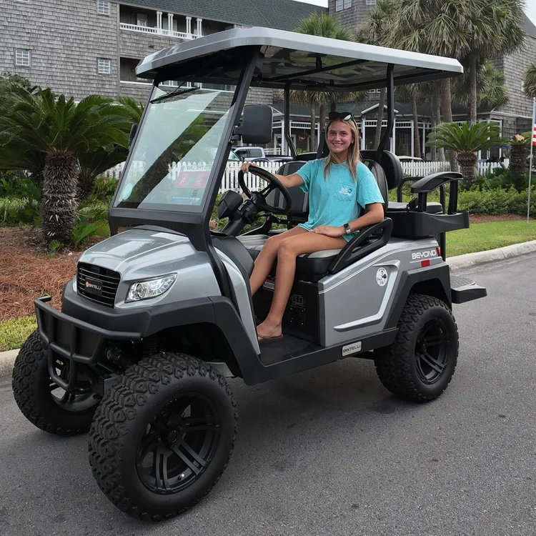 A guest behind the wheel of a Beach Better street-legal golf cart rental in Miramar Beach