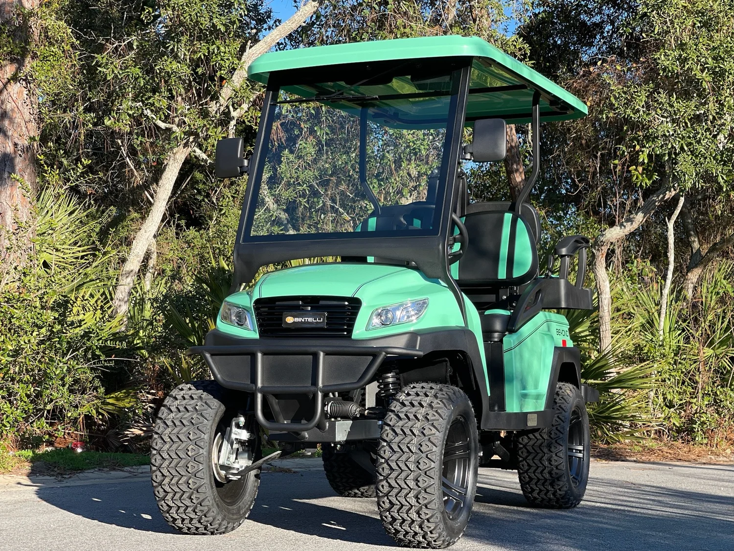 L4MB05L mint green lifted 4 seat electric street legal golf cart LSV on the Emerald Coast