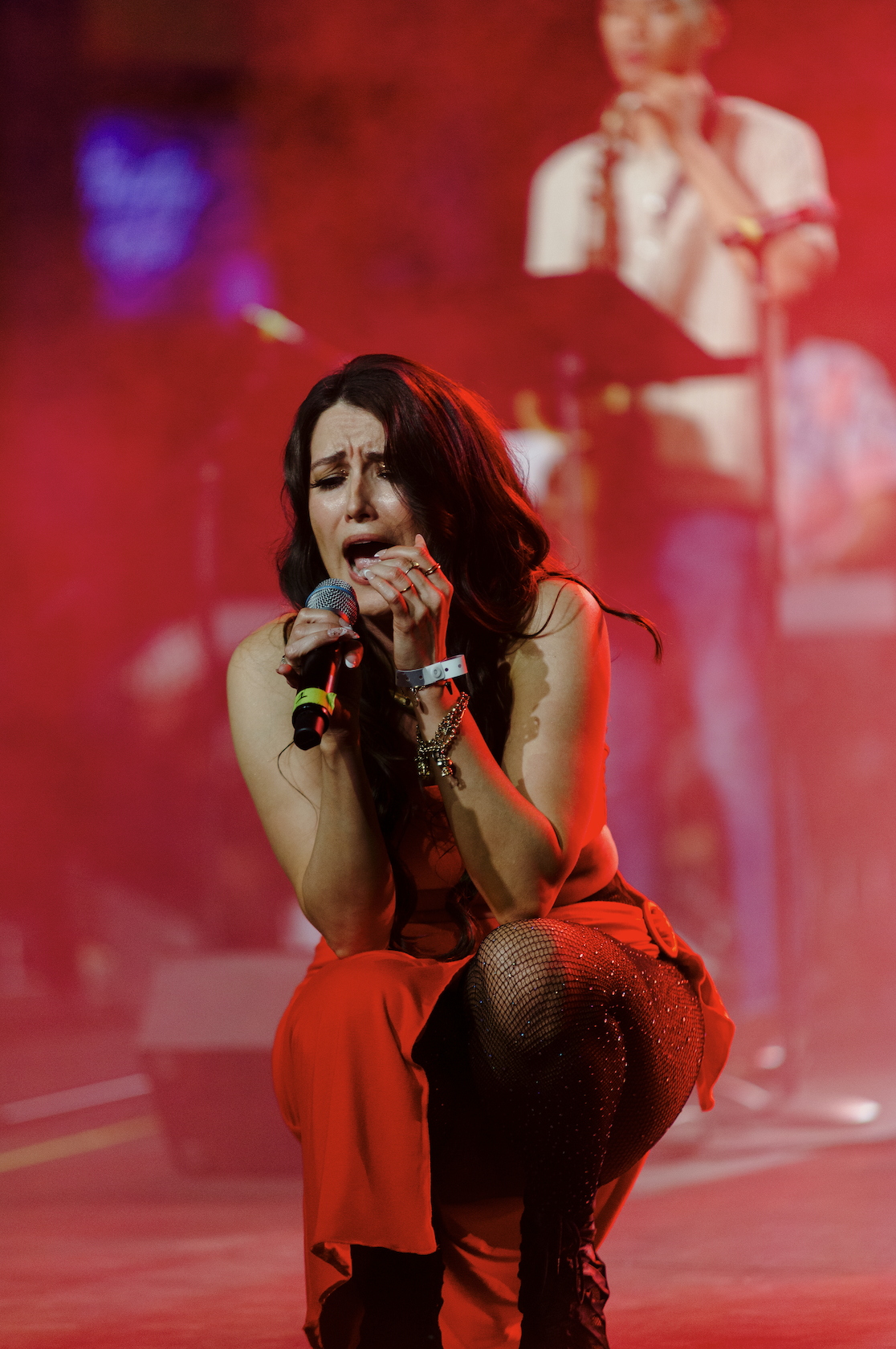 A passionate performer sings on stage at IMMERSE