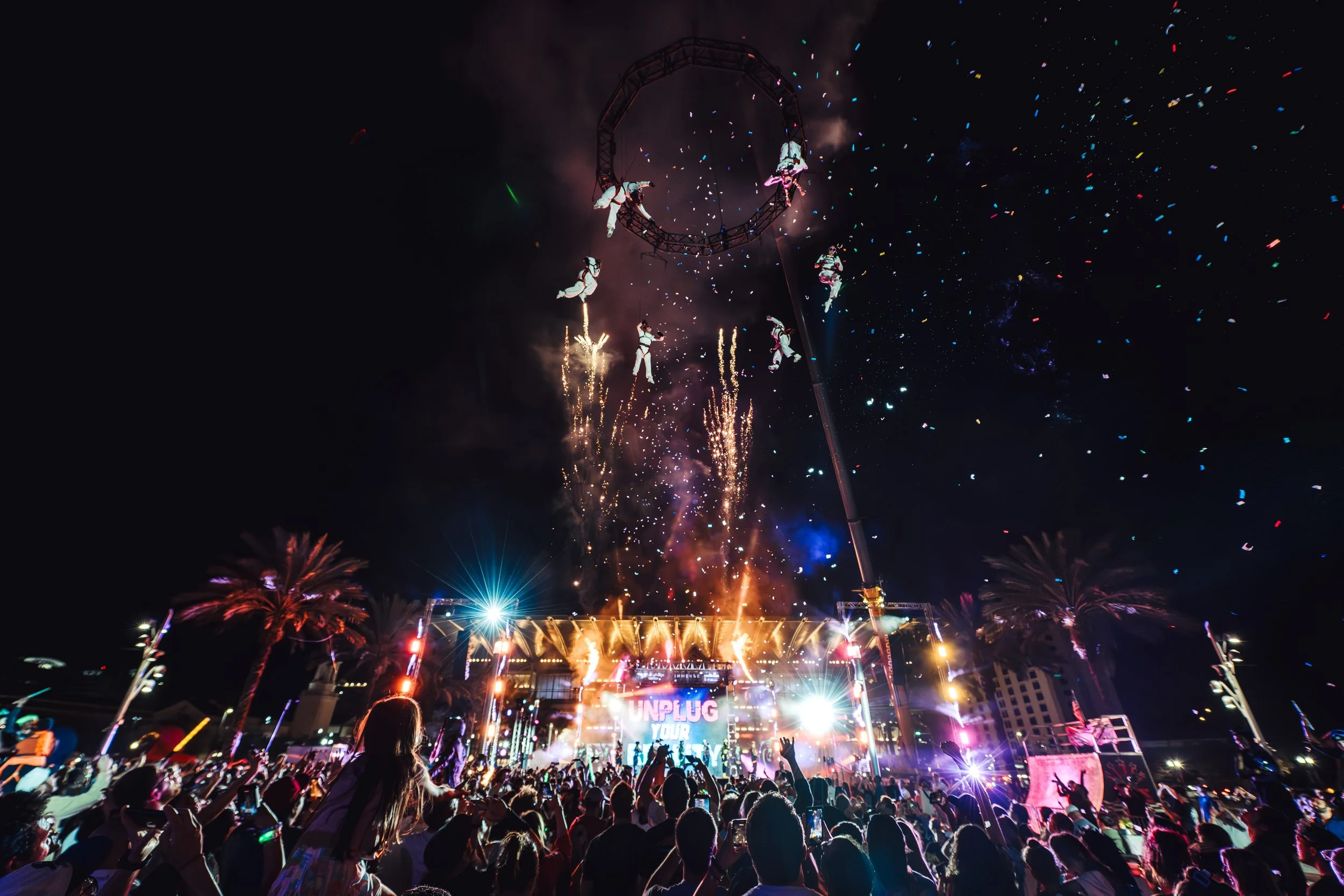 Acrobats from MESH perform at IMMERSE including acrobats hanging from a crane overhead