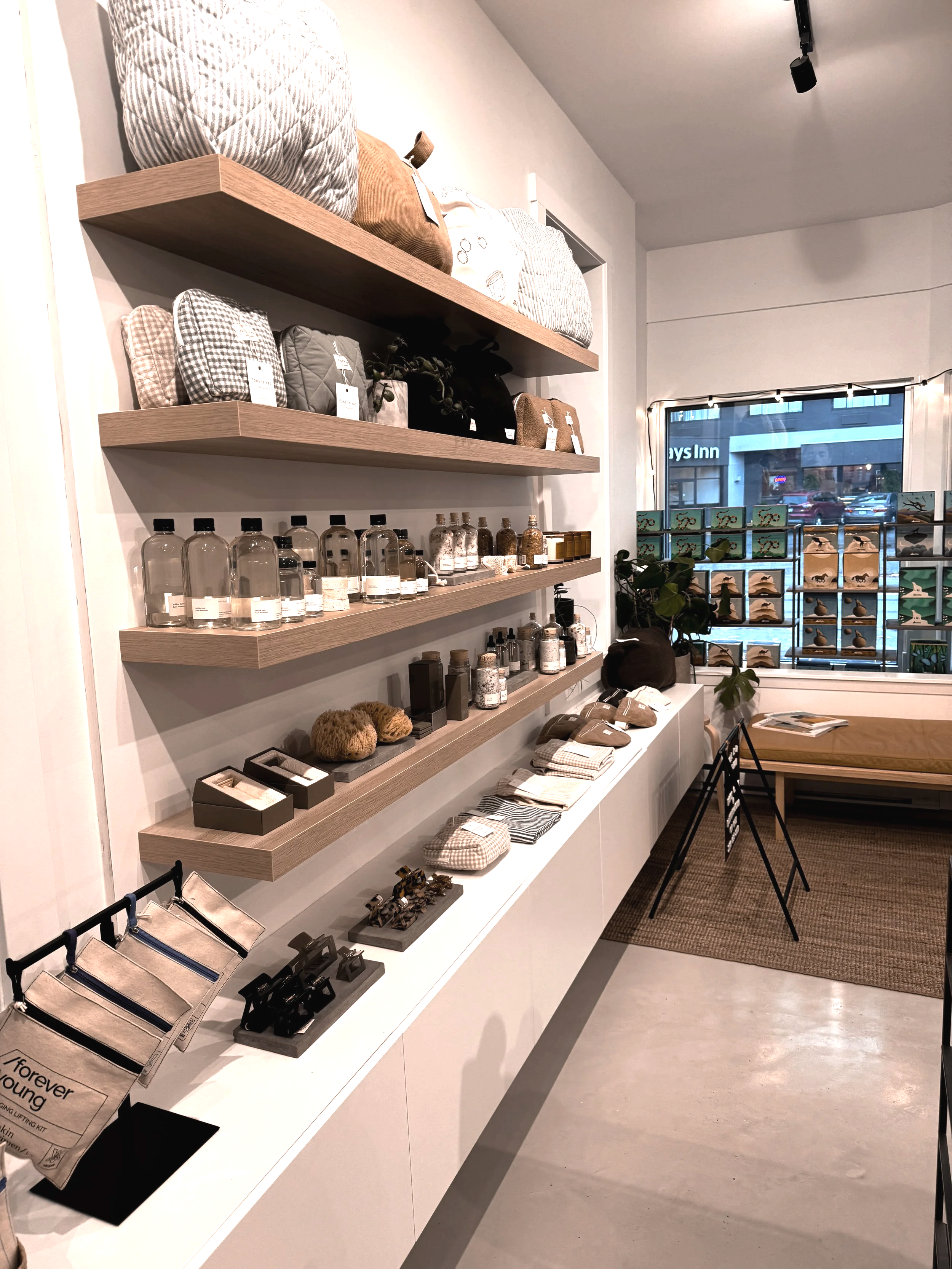 Butter shop shelves with curated pillows, bottles, candles, and lifestyle products for sale