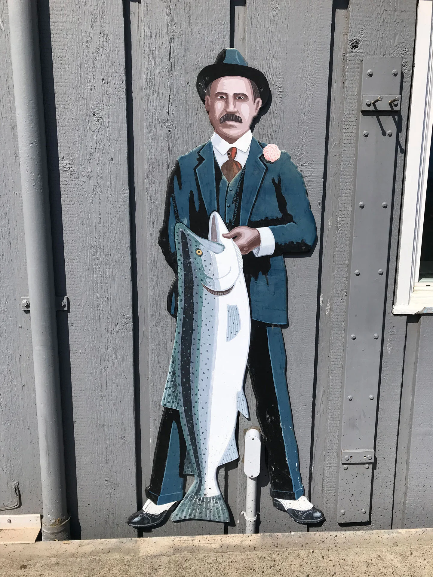 Will Lowman, cannery owner with big King salmon, 1907.
