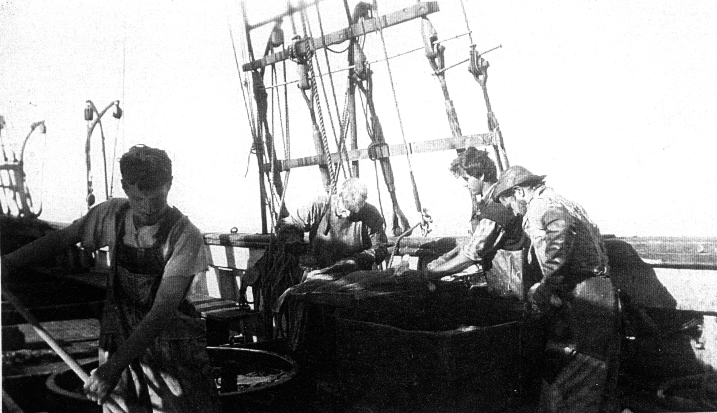  Wawona crew (l to r) Jack Lee, Kerrigan (splitter), unknown, Bud Smith (header). Person by tub is the "idler", who puts the fish in the head-in box (first step of cleaning process), puts the split fish (attached at backbone) down "shoot" (hole) into