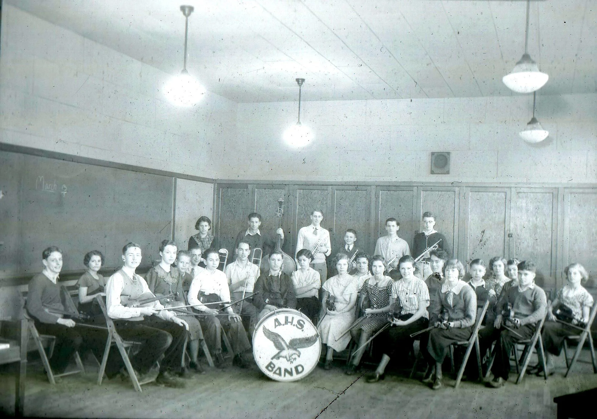  The Anacortes High School orchestra of 1934-35 is seated in their classroom. This image was published in the 1935 annual on page 43. Under the direction of Miss Inez Jackson, the members included ARNOTT, Ralph, BENSON, Virginia, DILDINE, Richard, FE