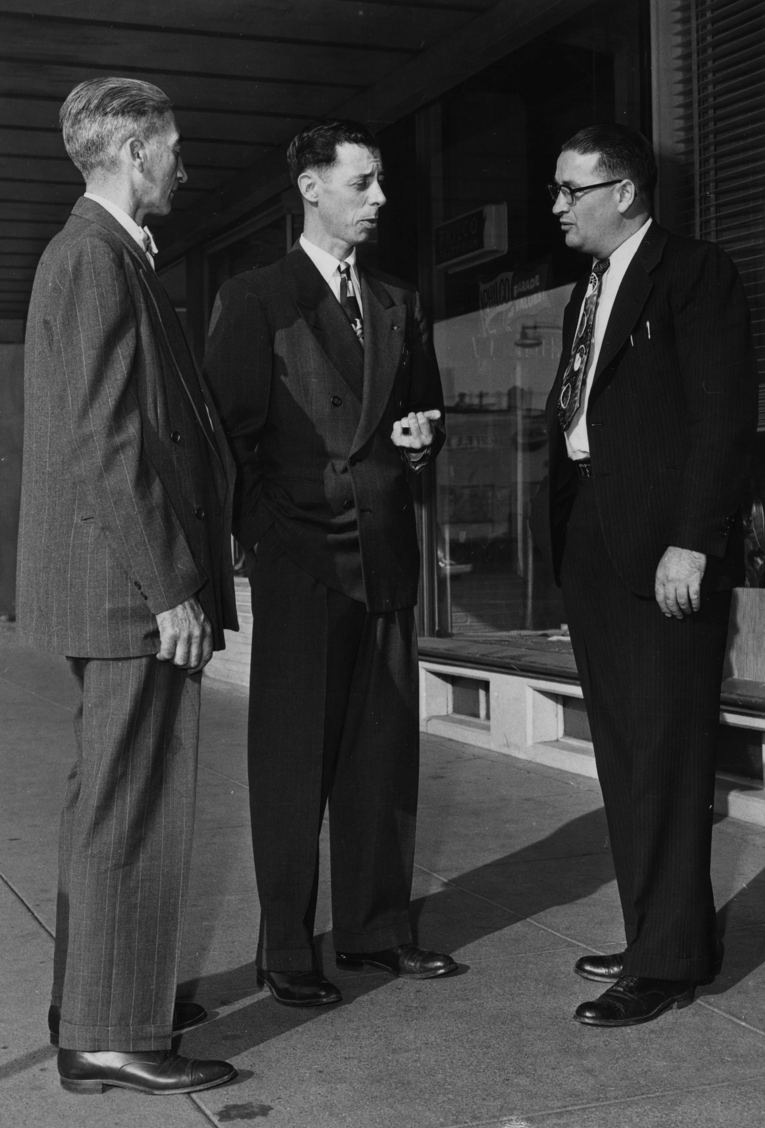  Citizens discussing survey done for community study.  Left to right:   Lloyd Steinman (Steinman's Grocery), Dr. Jim Hurley (optometrist), Anacortes Superintendent of Schools Clarence Henning   —  Anacortes Museum Historical Archive  