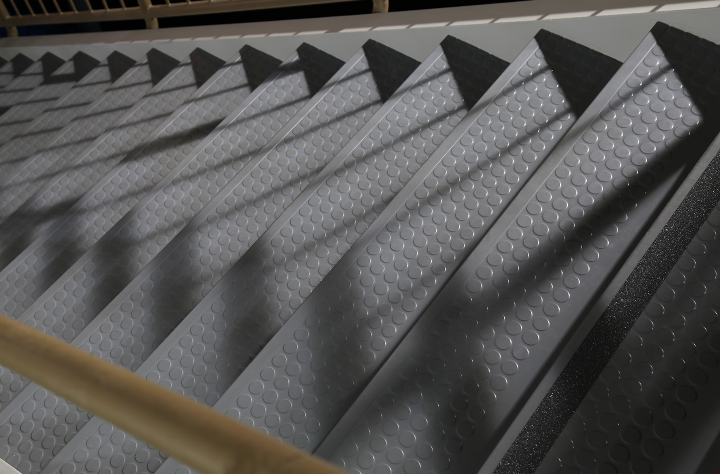 Rubber stair treads with visually impaired stripes for code compliance