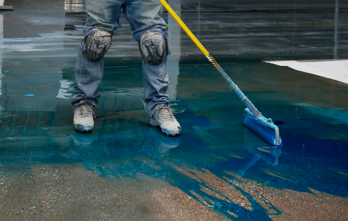 Image of installer spreading Sika MB moisture mitigation product