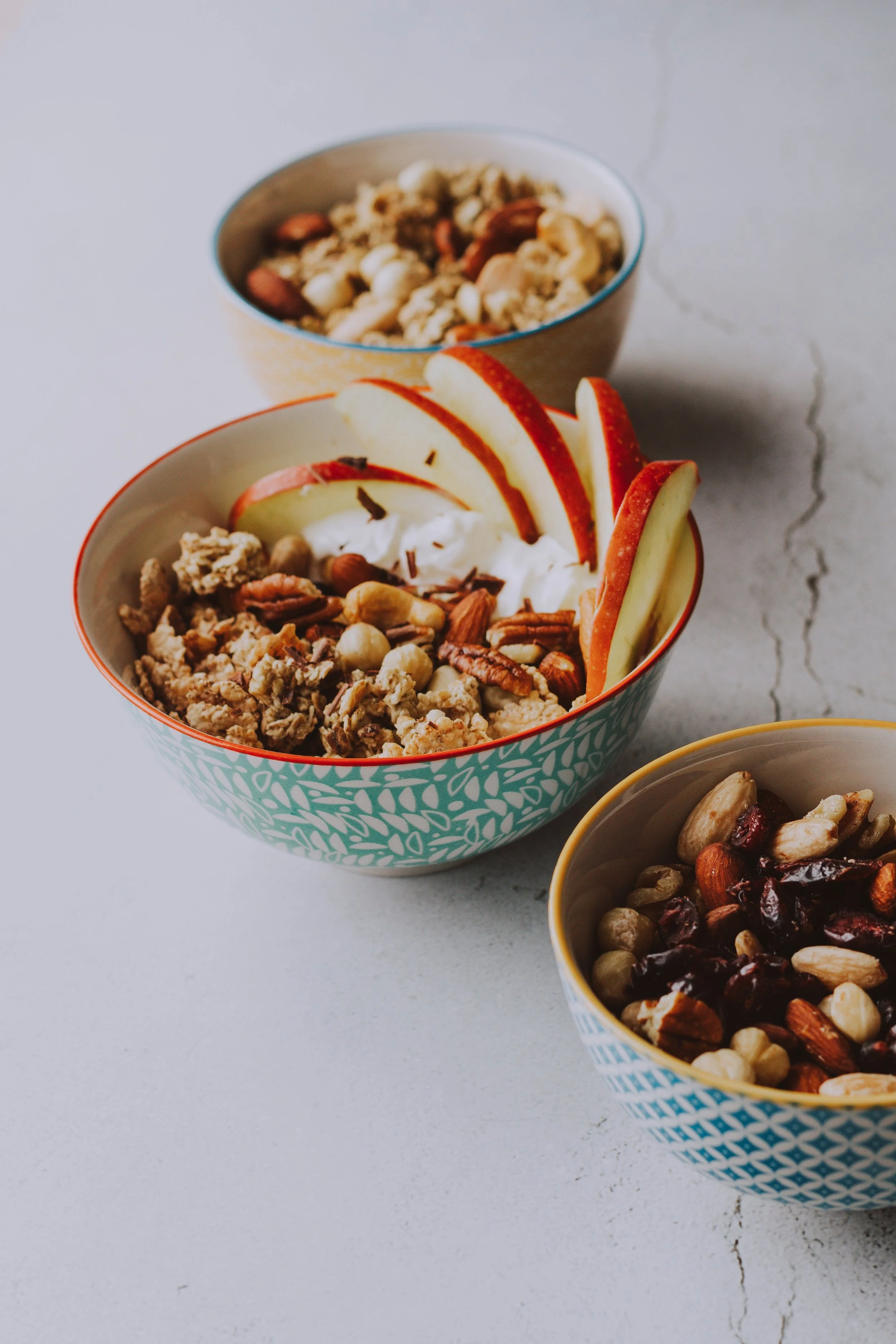 yogurt bowl with granola, nuts, and apples