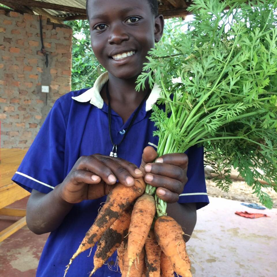 Sabina student with bunch of carrots from garden.jpg