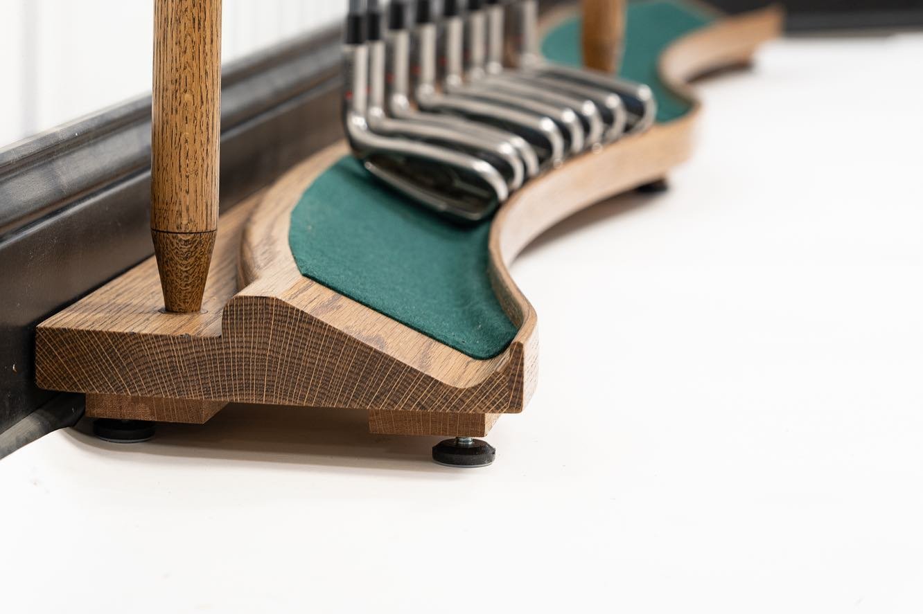 This golf club rack was custom designed for a golf simulator room in the Upper West Side of Manhattan NYC. They wanted it to hold two full sets of clubs, 14 on each side: one for the homeowner and one for a friend to set up their clubs, since the sim
