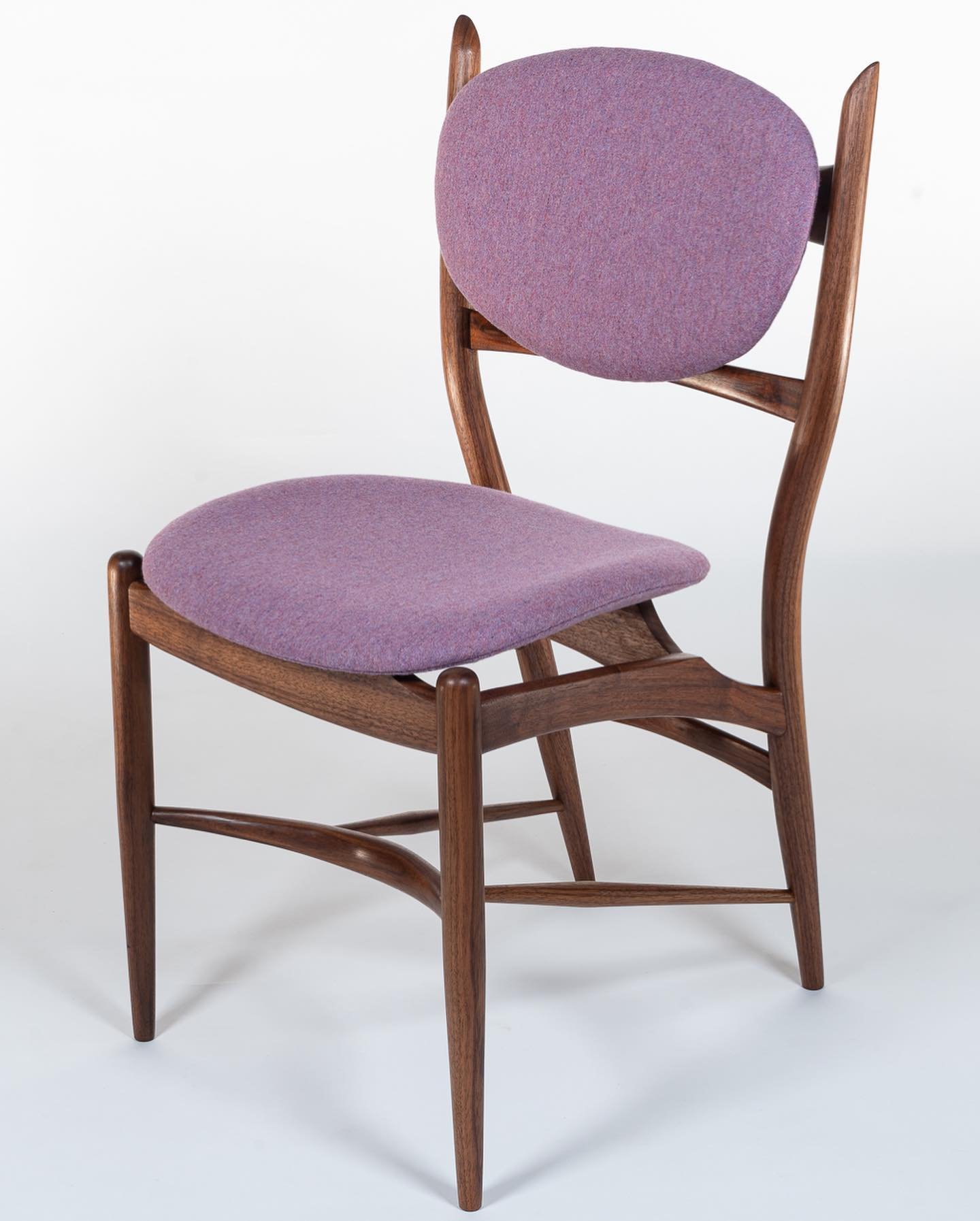 I&rsquo;ve decided to call it the Ambassador chair. It has a bold stance that commands the attention of anyone who catches a glimpse. Highlighting negative space, the soft cushions appear to float above the complex walnut frame. True to its namesake,