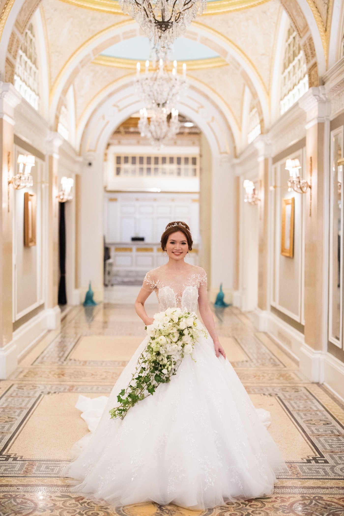 Bride carrying a bouquet of white roses, snapdragon, and ivy by Flou(-e)r Specialty Floral Events