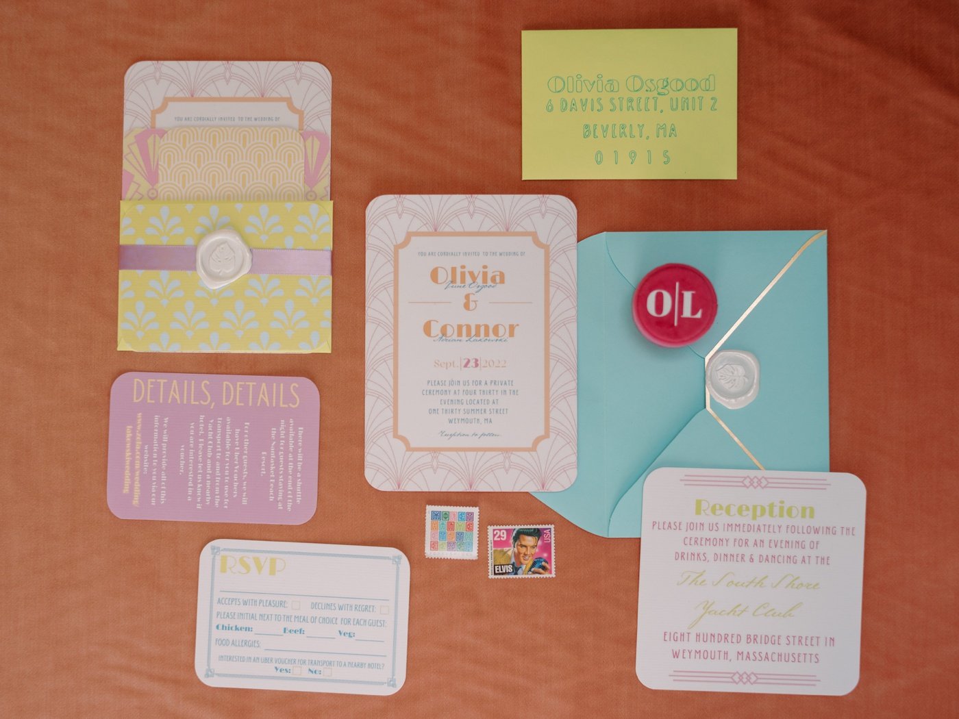 Flat lay of a colorful art deco-style invitation suite for a wedding