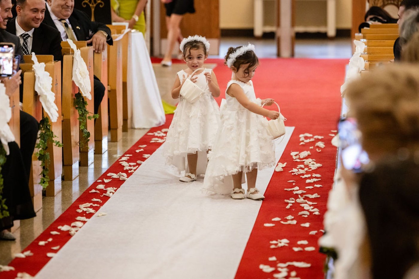 Flower girls tossing petals into the aisle at a Greek Orthodox wedding ceremony in Boston